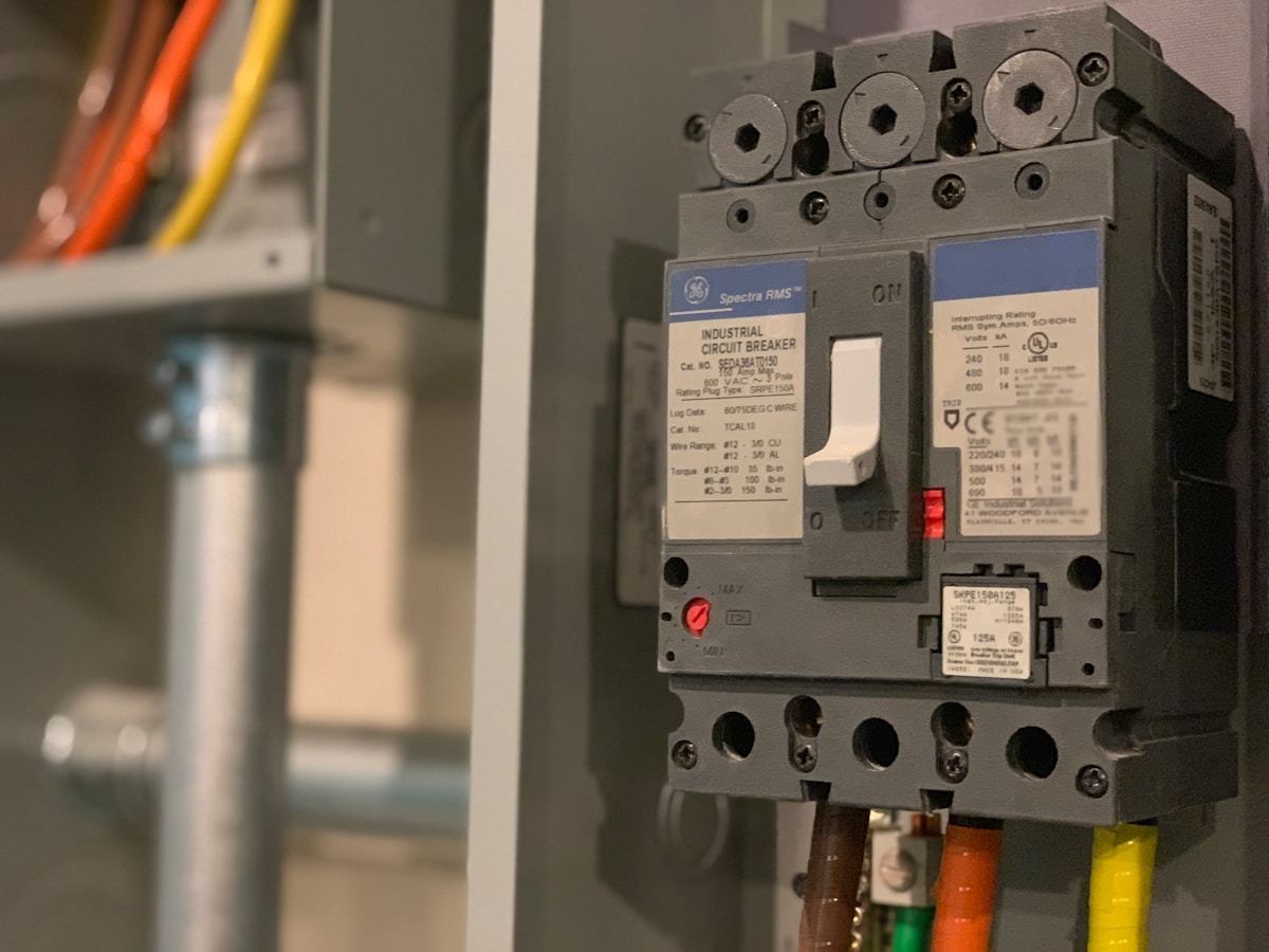 Residential electrical panel with breaker slots — each dedicated circuit needs its own breaker slot