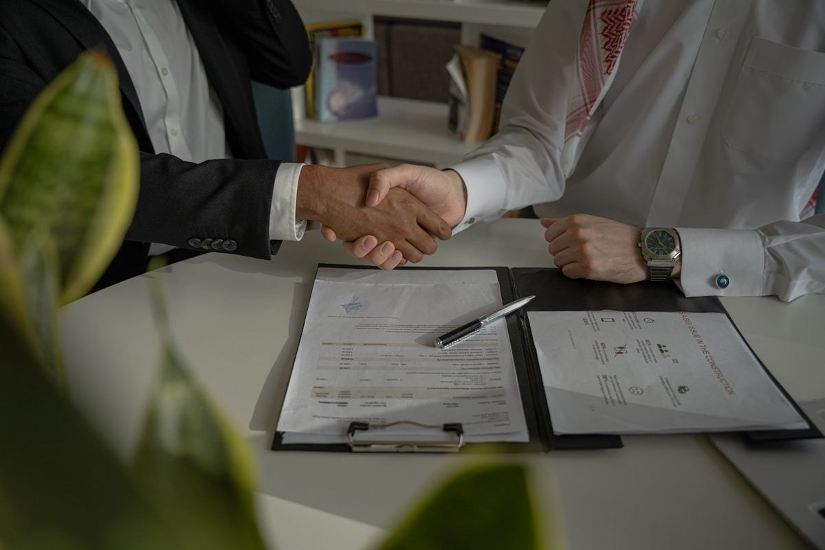 Homeowner and contractor shaking hands — the moment you commit to hiring an electrician
